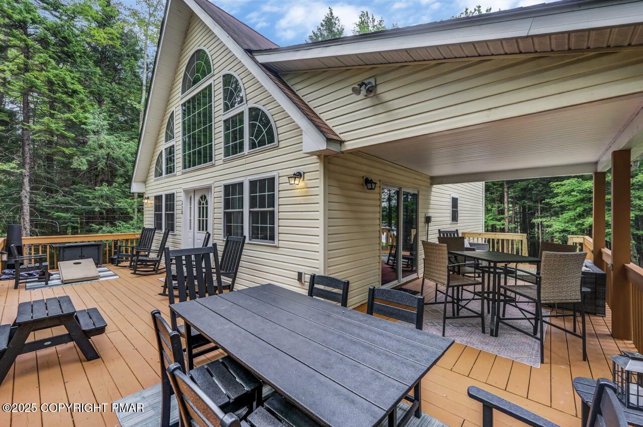 238 King Arthur Road Pocono Lake, PA 18347 - Photo 14 of 95 a view of a patio with table and chairs and wooden floor
