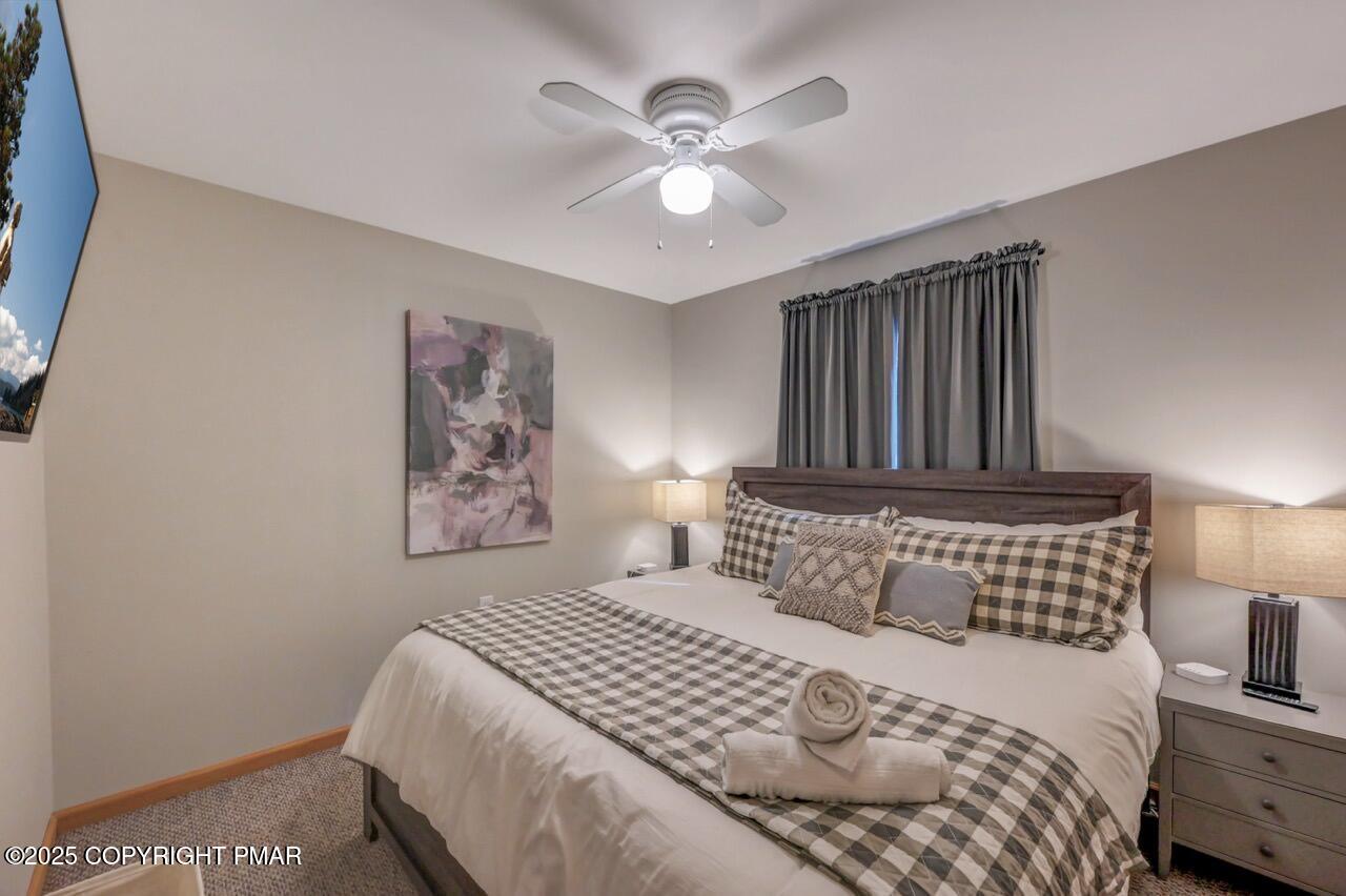 238 King Arthur Road Pocono Lake, PA 18347 - Photo 41 of 95 a bedroom with a bed and a chandelier