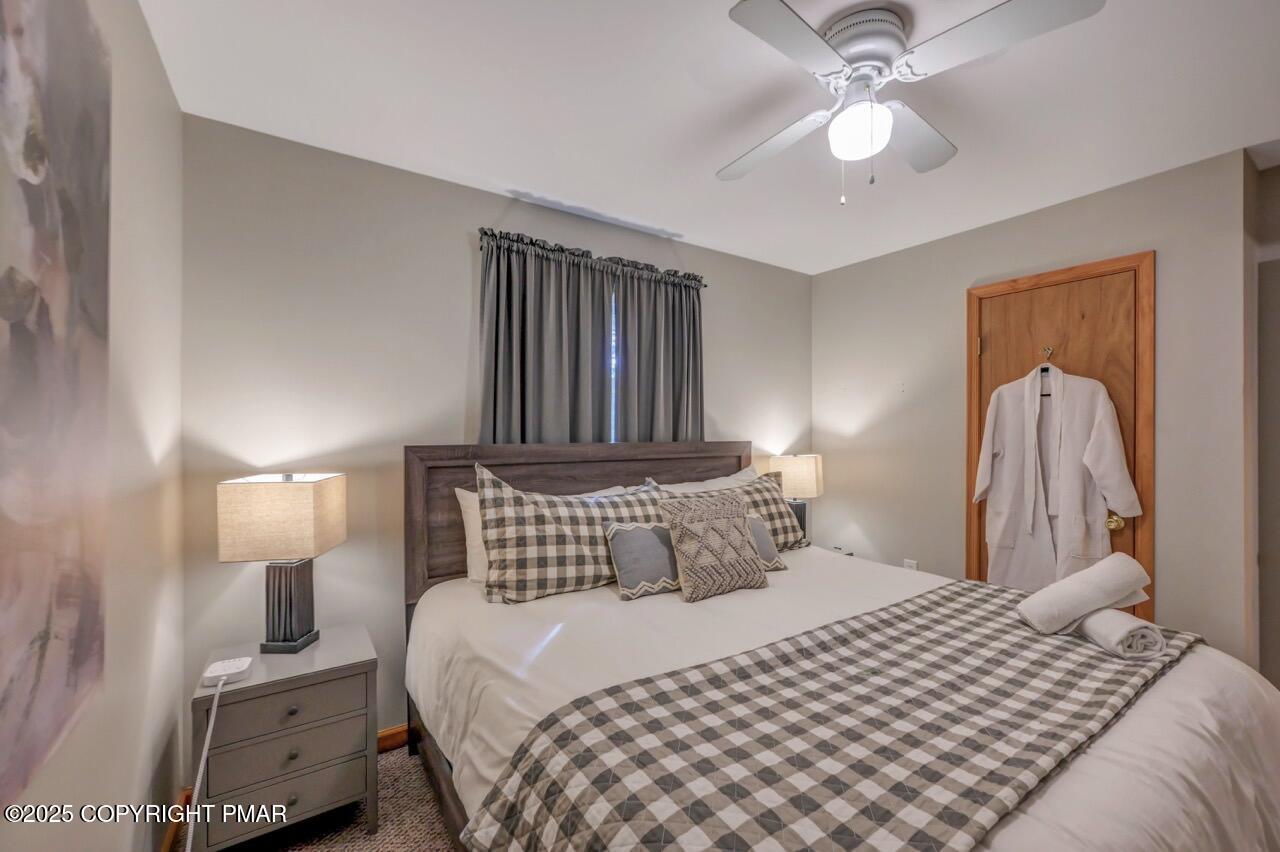 238 King Arthur Road Pocono Lake, PA 18347 - Photo 42 of 95 a bedroom with a bed and a lamp