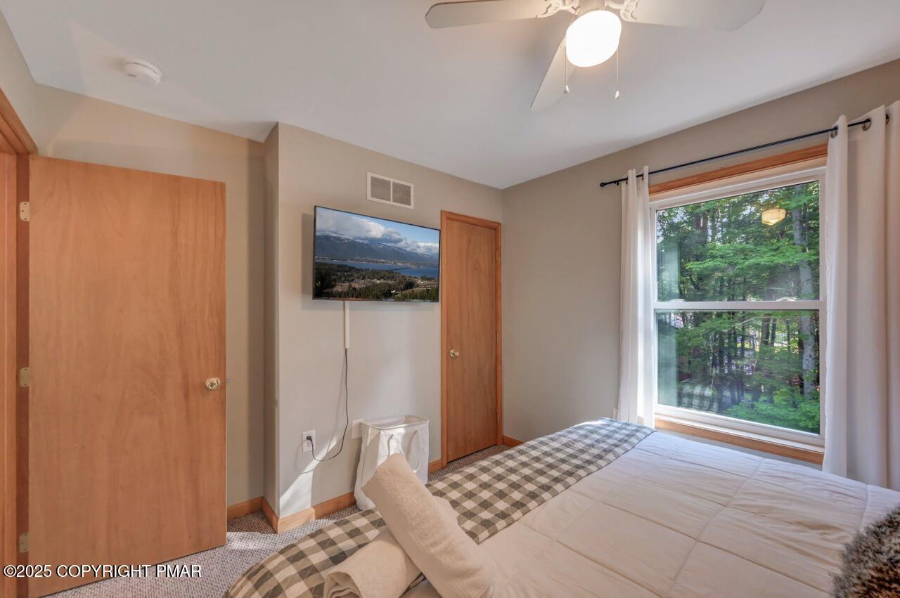 238 King Arthur Road Pocono Lake, PA 18347 - Photo 55 of 95 a bedroom with a bed and a flat screen tv