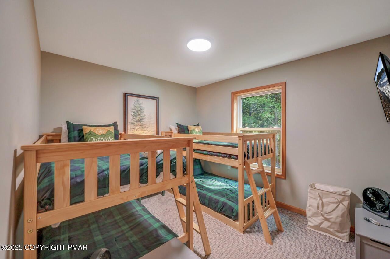 238 King Arthur Road Pocono Lake, PA 18347 - Photo 56 of 95 a bedroom with a bed and a window