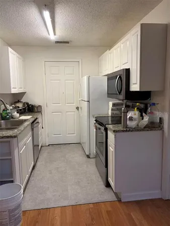 a kitchen with a sink a stove and a refrigerator