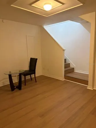a view of a room with wooden floor and furniture