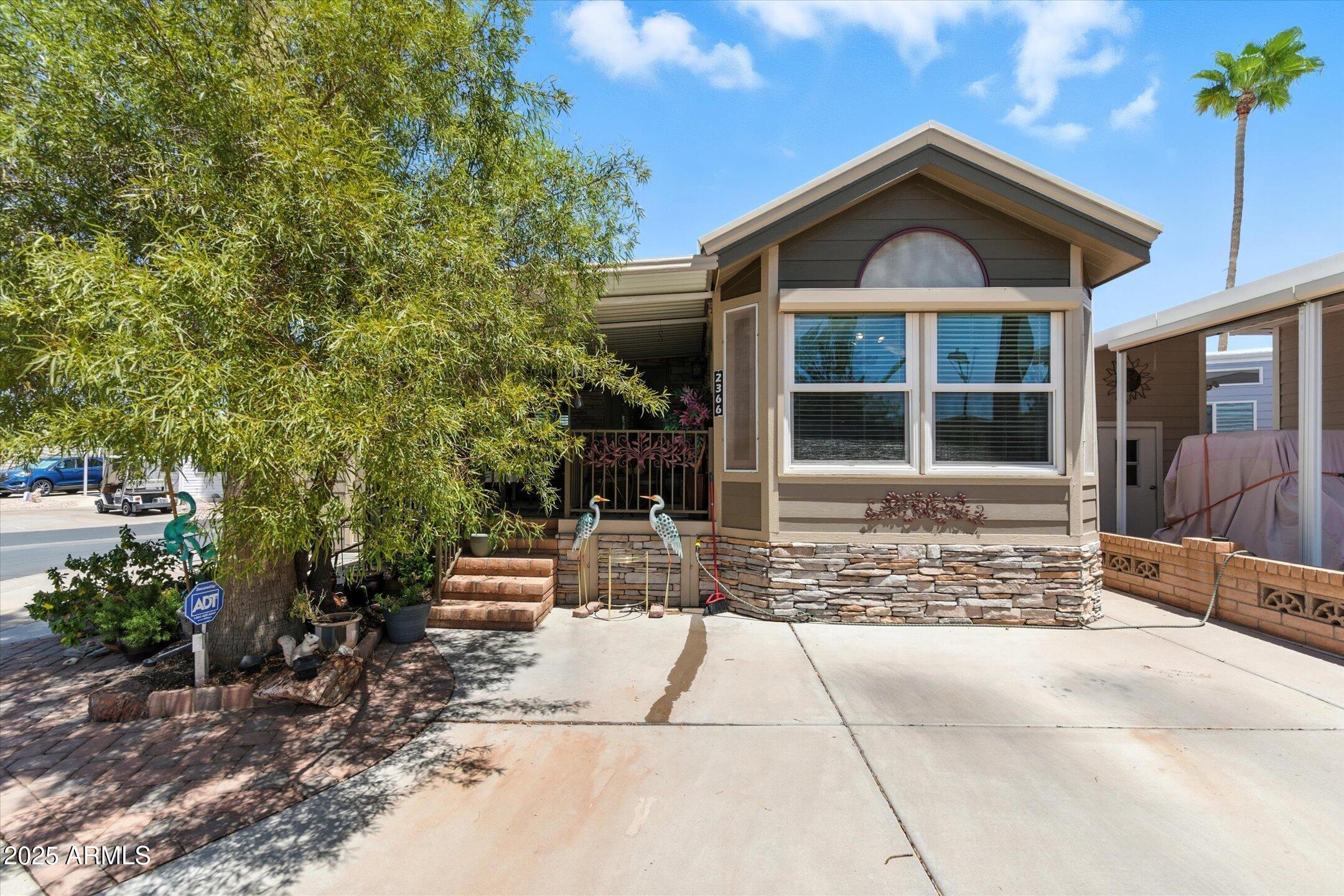 2366 East Pima Avenue Apache Junction, AZ 85119 - Photo 1 of 22 a front view of a house with a yard