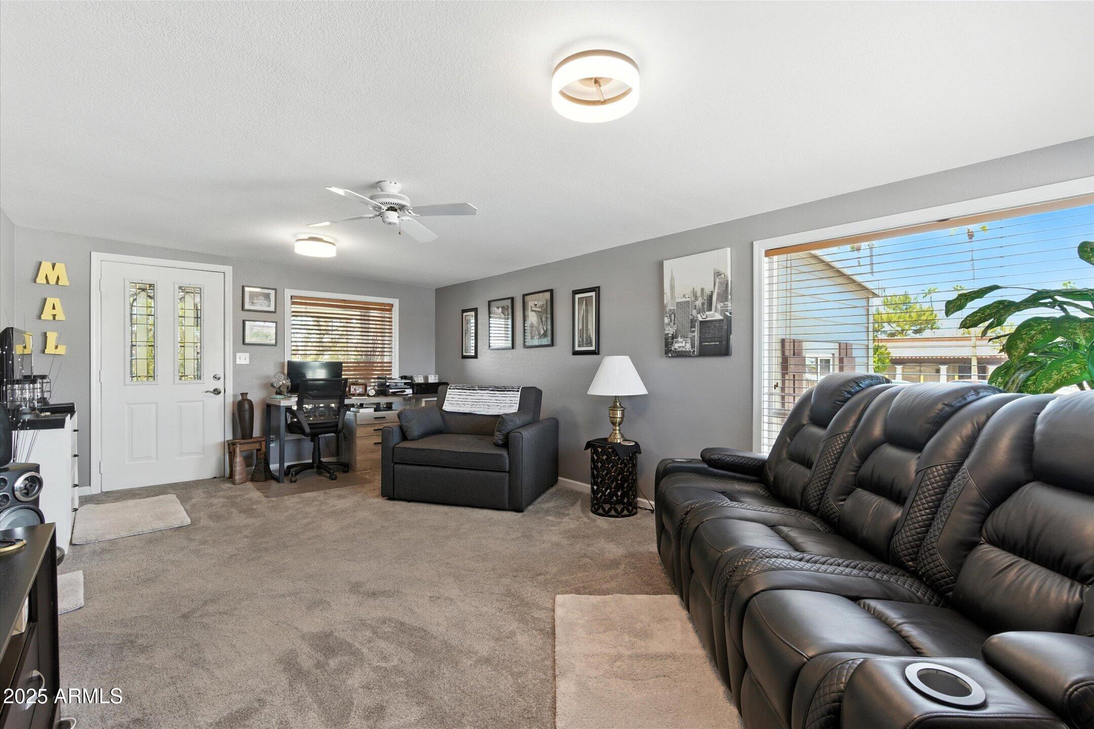 2366 East Pima Avenue Apache Junction, AZ 85119 - Photo 11 of 22 a living room with furniture ceiling fan and a window