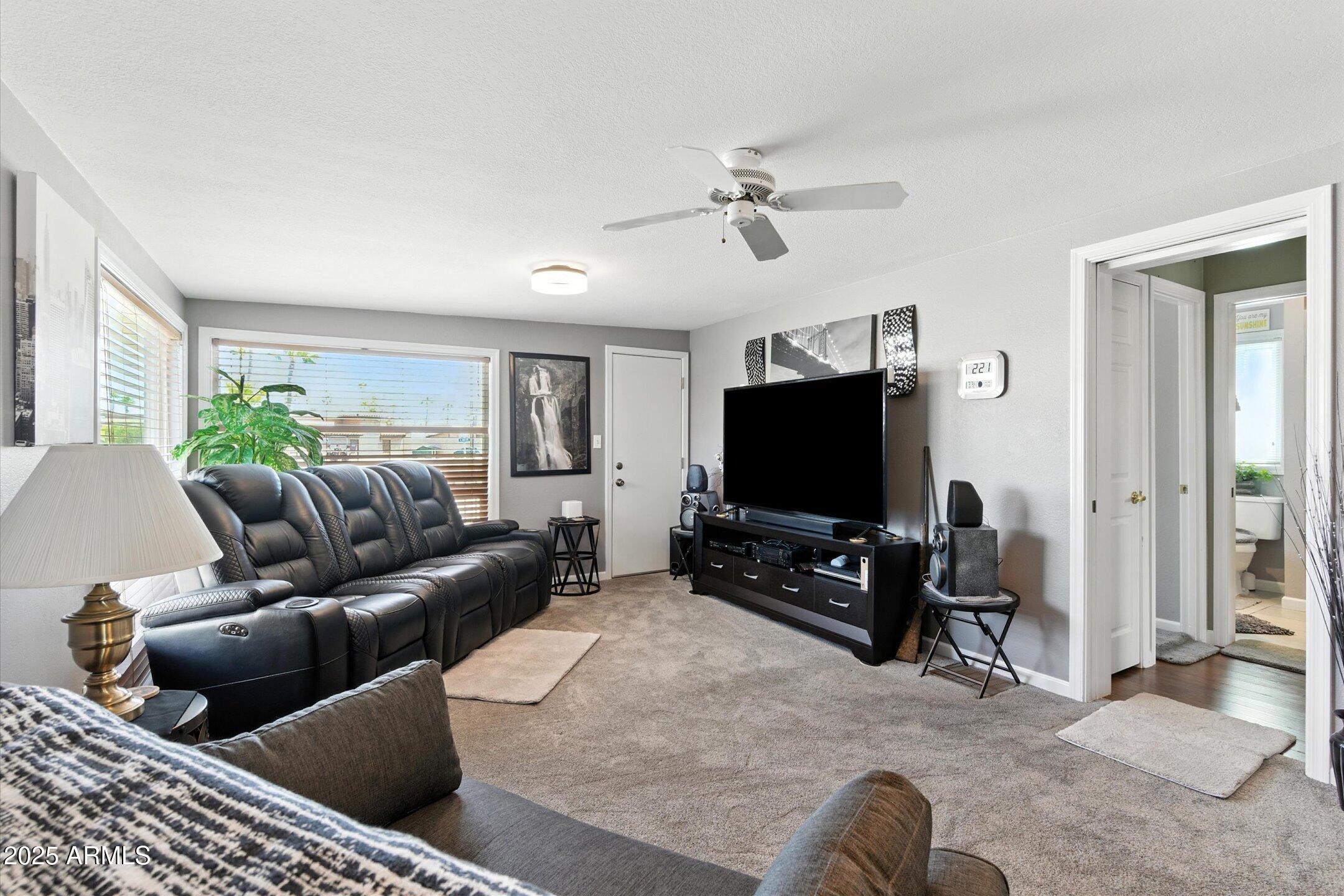 2366 East Pima Avenue Apache Junction, AZ 85119 - Photo 12 of 22 a living room with furniture and a flat screen tv
