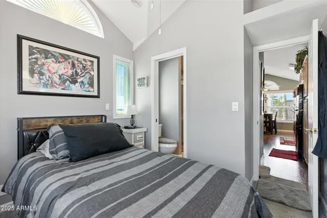 a bedroom with a bed and a wall painting