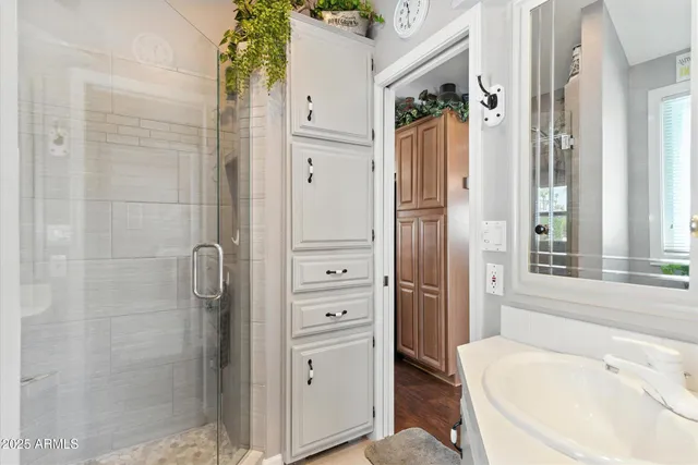 a bathroom with a tub shower and sink