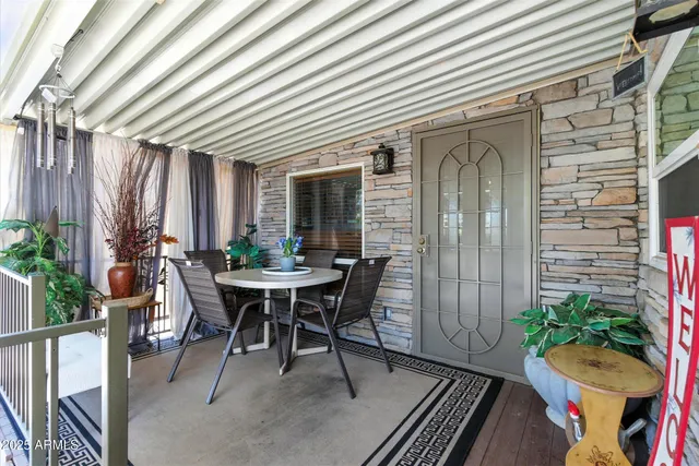 a view of a dining room with furniture and potted plant