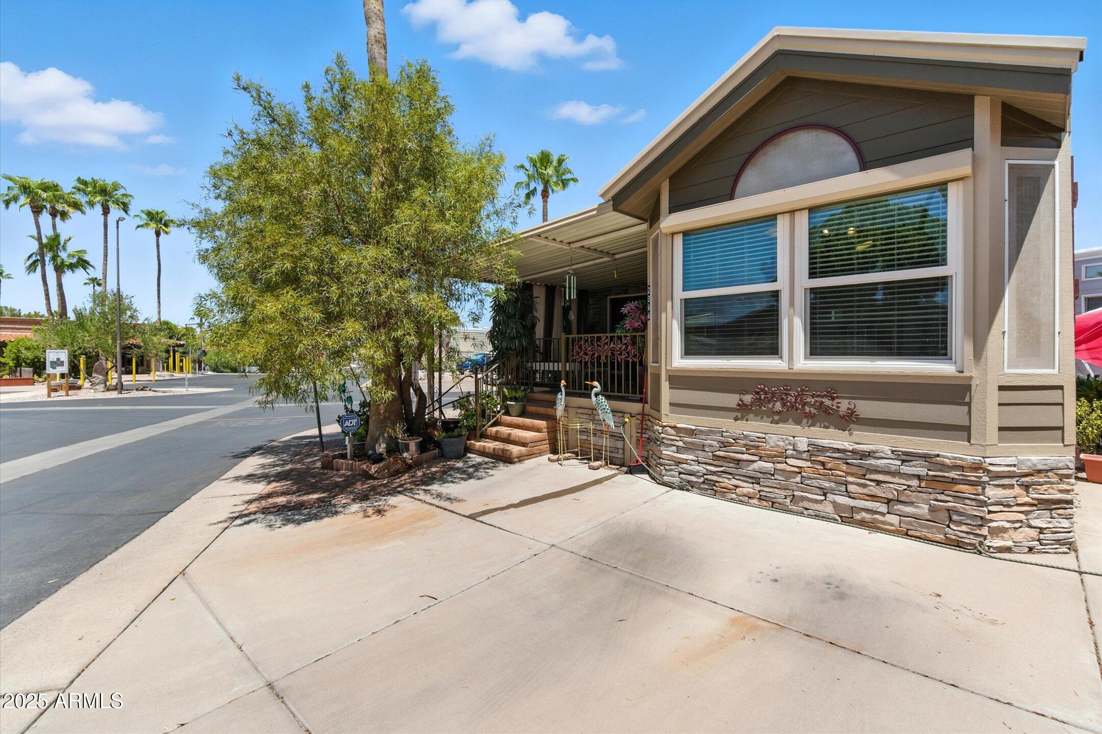 2366 East Pima Avenue Apache Junction, AZ 85119 - Photo 2 of 22 a front view of a house with a yard