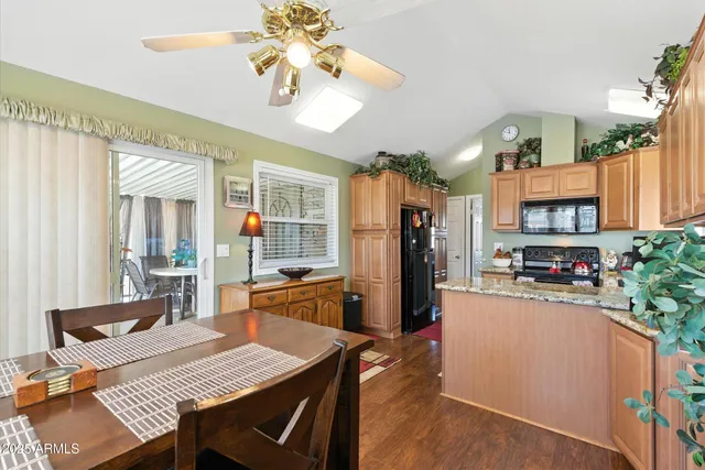 a kitchen with stainless steel appliances granite countertop sink stove and wooden cabinets