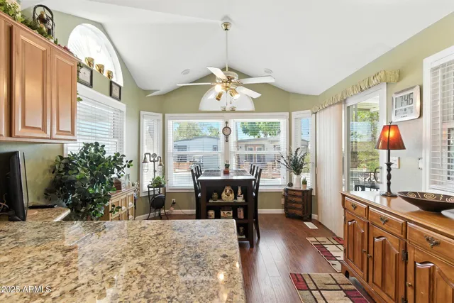 a kitchen with a table chairs appliances and cabinets