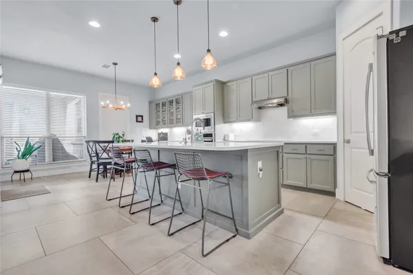 a kitchen with kitchen island granite countertop a counter space a sink appliances and cabinets