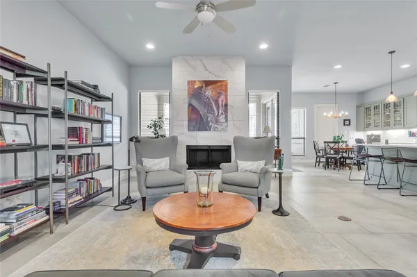 a living room with furniture a rug and a book shelf