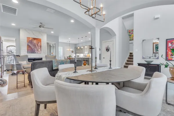 a living room with furniture a dining table and chairs