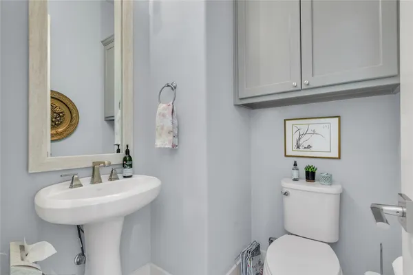 a bathroom with a toilet sink and mirror