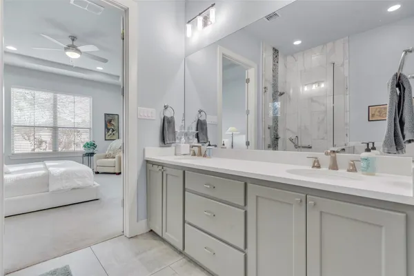 a bathroom with a double vanity sink mirror and double