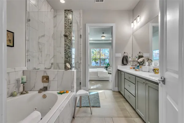 a bathroom with a tub sink and mirror