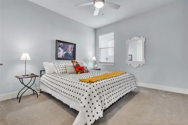 a bedroom with bed and a chandelier