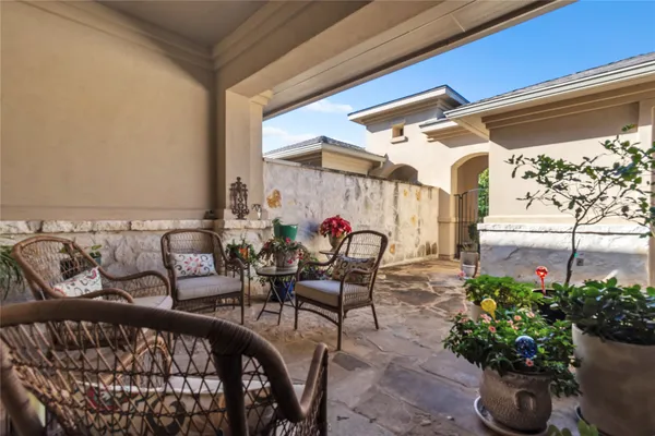 a view of a patio with furniture and a potted plant