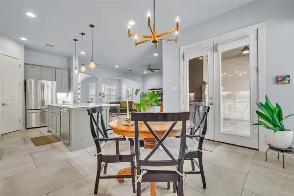 a dining room with furniture and a kitchen view