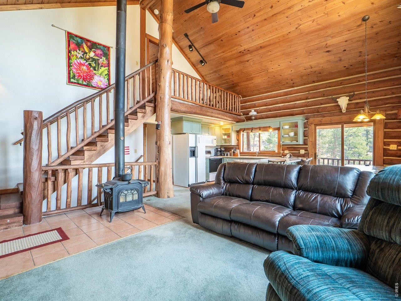 296 Caddo Road Red Feather Lakes, CO 80545 - Photo 5 of 50 Great room with vaulted tongue & groove ceilings, open log staircase & wood burning stove.