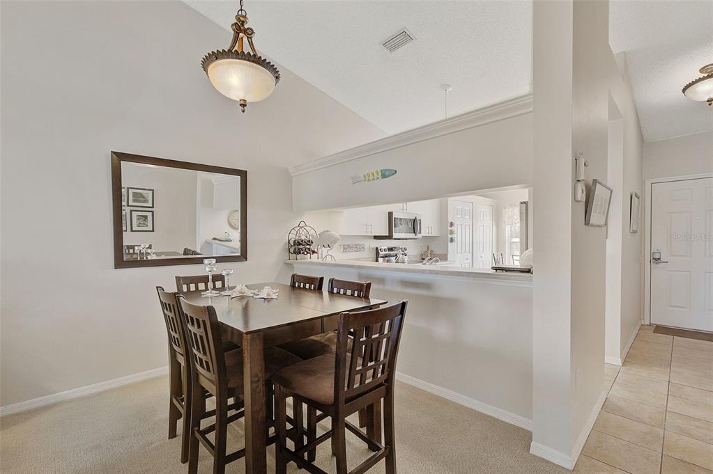 4706 Sand Trap St Circle, Unit 202 Bradenton, FL 34203 - Photo 11 of 33 a view of a dining room with furniture