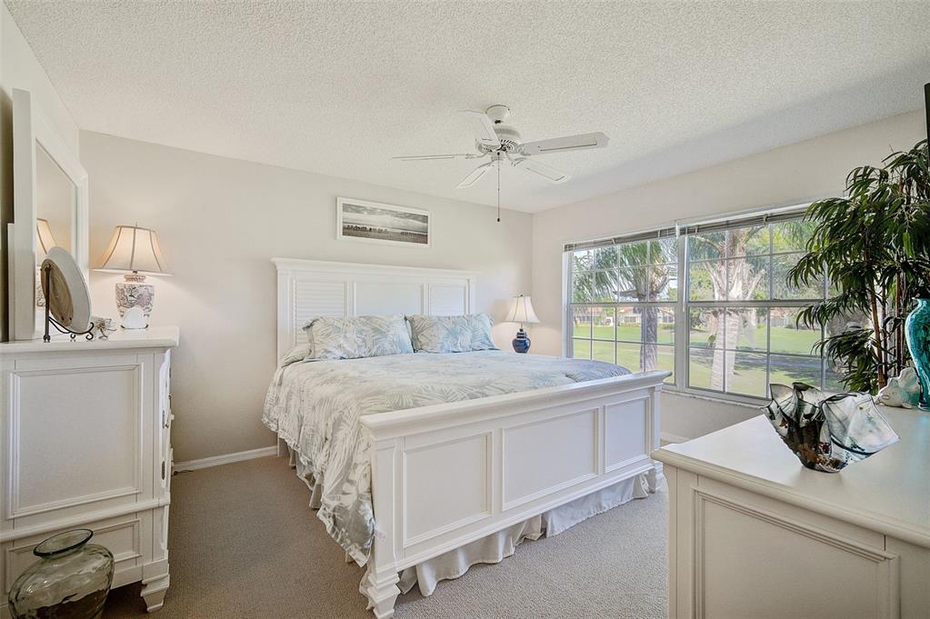 4706 Sand Trap St Circle, Unit 202 Bradenton, FL 34203 - Photo 17 of 33 a bedroom with a bed and a large window
