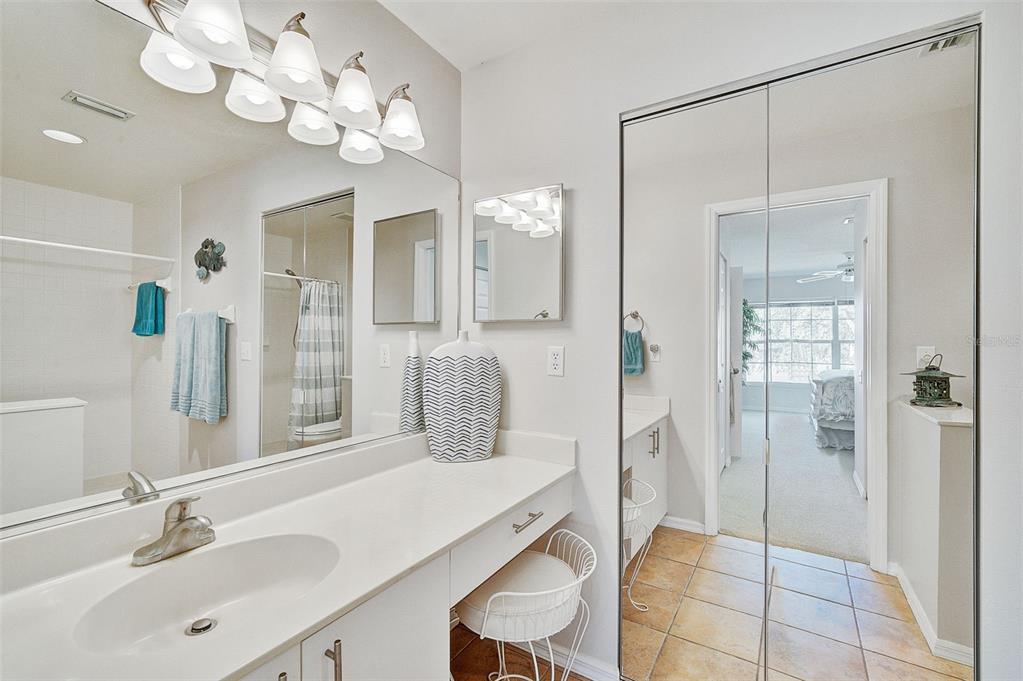 4706 Sand Trap St Circle, Unit 202 Bradenton, FL 34203 - Photo 19 of 33 a bathroom with a sink a mirror and a shower