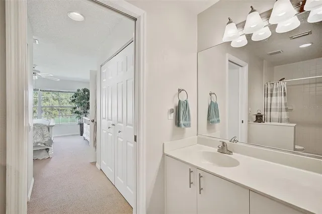 a bathroom with a sink vanity and a mirror