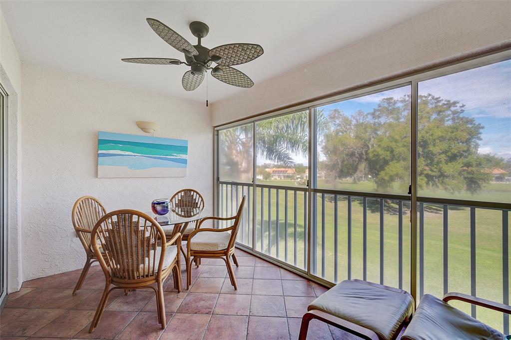 4706 Sand Trap St Circle, Unit 202 Bradenton, FL 34203 - Photo 26 of 33 a view of a dining room with furniture window and wooden floor
