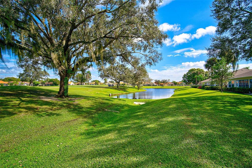4706 Sand Trap St Circle, Unit 202 Bradenton, FL 34203 - Photo 31 of 33 a view of a park with large trees
