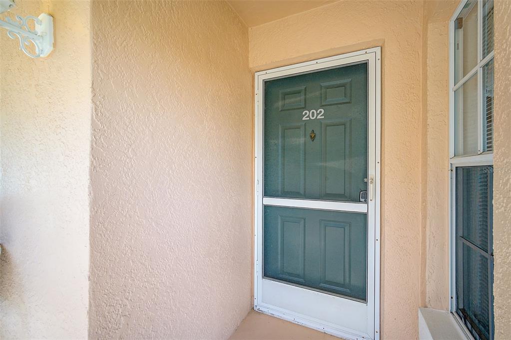 4706 Sand Trap St Circle, Unit 202 Bradenton, FL 34203 - Photo 5 of 33 a bathroom with a glass door shower and vanity