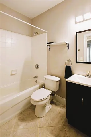 a spacious bedroom with a bed and wooden floor