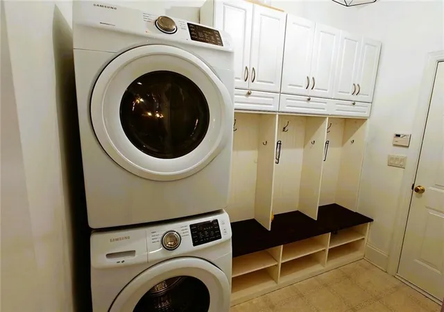 a bathroom with a granite countertop sink mirror and a bathtub