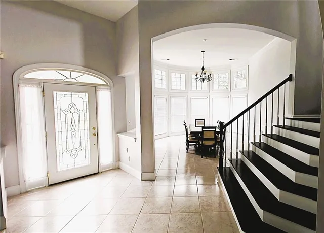 a view of a dining room with furniture and a chandelier