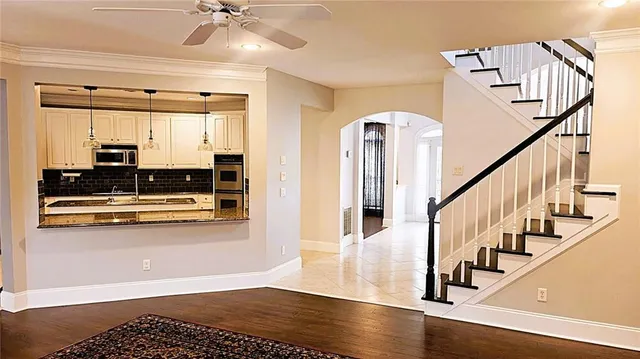 a living room with furniture and a table with wooden floor