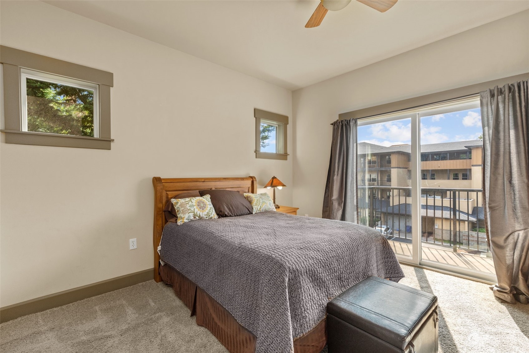 2115 201st Place Southeast, Unit D1 Bothell, WA 98012 - Photo 14 of 33 a bedroom with a bed and a large window