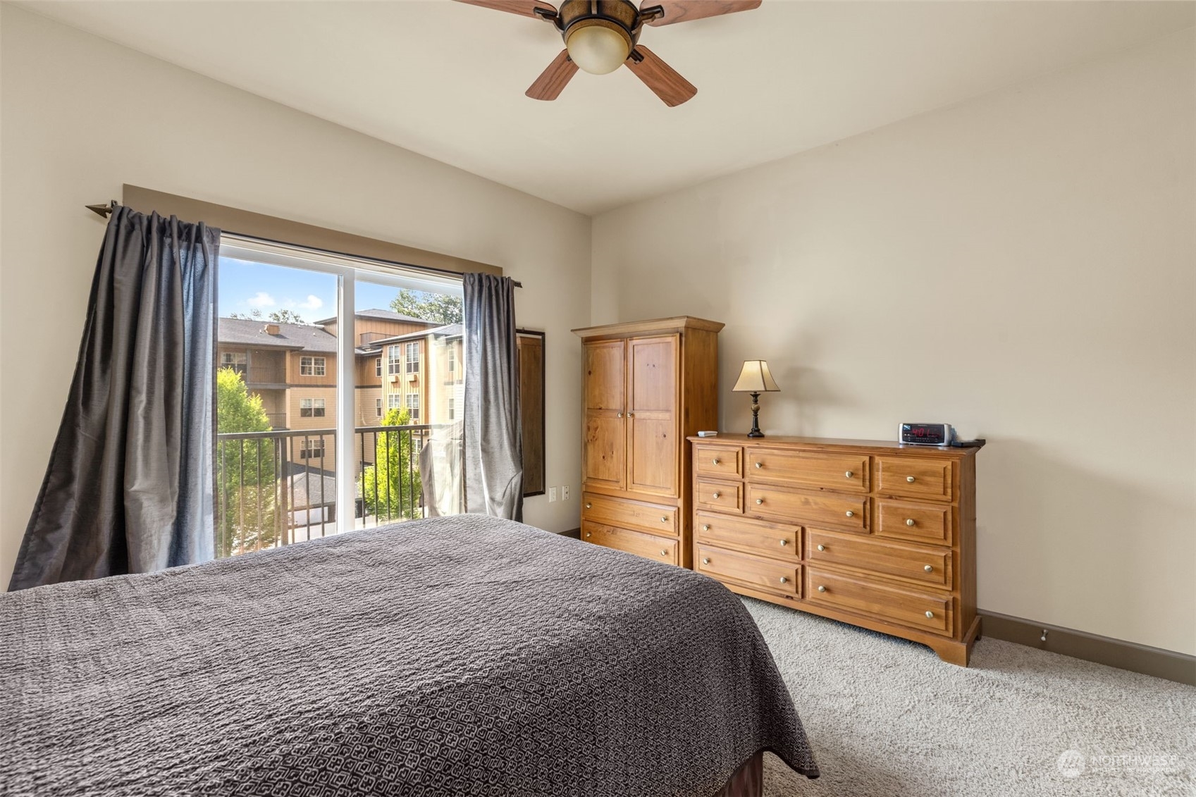 2115 201st Place Southeast, Unit D1 Bothell, WA 98012 - Photo 15 of 33 a bedroom with a bed dresser and a large window
