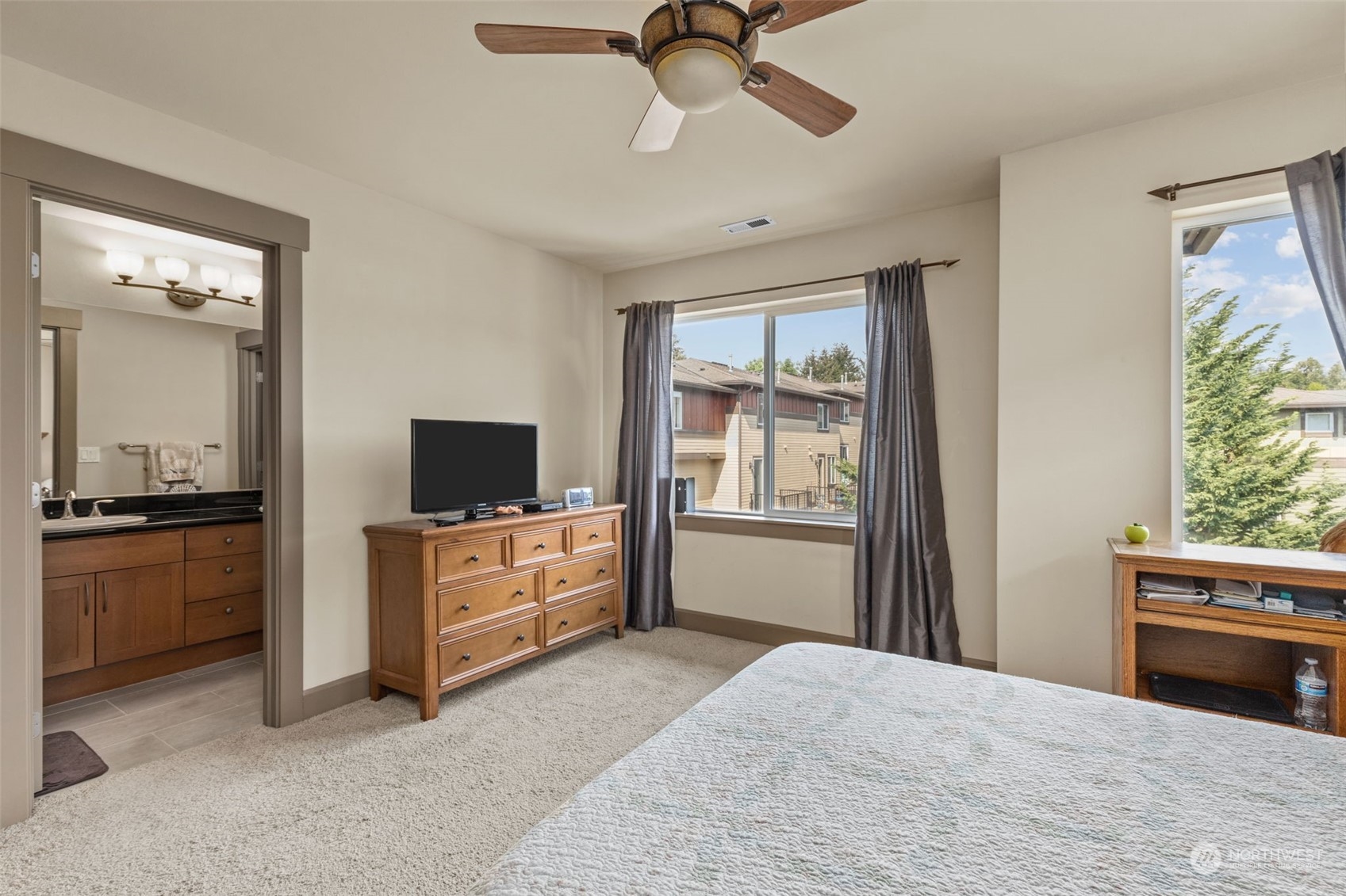 2115 201st Place Southeast, Unit D1 Bothell, WA 98012 - Photo 26 of 33 a bedroom with a bed and a flat screen tv