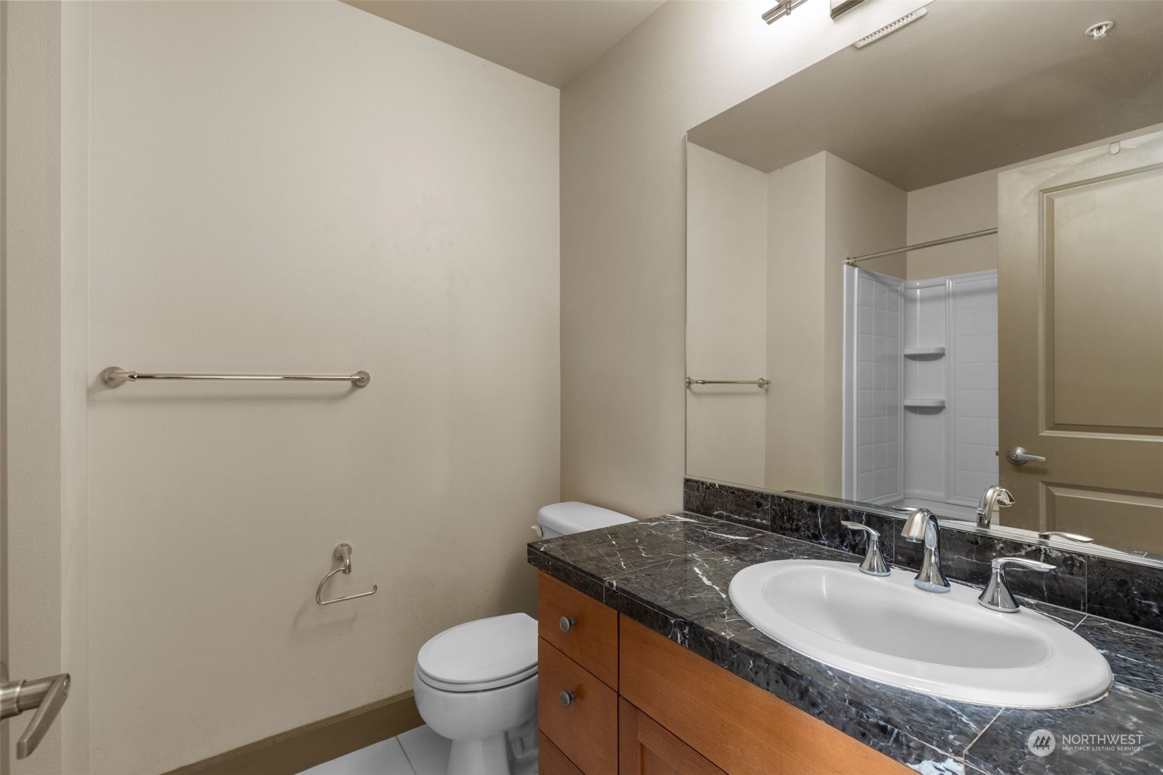 2115 201st Place Southeast, Unit D1 Bothell, WA 98012 - Photo 32 of 33 a bathroom with a granite countertop sink and a mirror with toilet