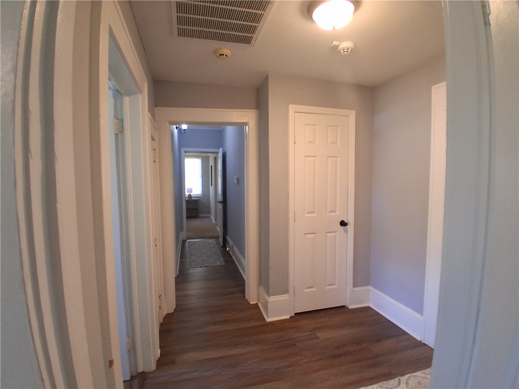 506 Pinckney Street Greenville, SC 29601 - Photo 14 of 29 Hallway view connecting bedrooms with warm flooring and modern finishes.