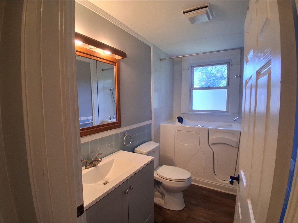 506 Pinckney Street Greenville, SC 29601 - Photo 19 of 29 Updated full bath featuring a modern vanity, walk-in tub, and natural light.