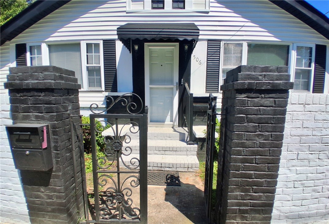 506 Pinckney Street Greenville, SC 29601 - Photo 2 of 29 Welcoming gated entry with charming historic details and added privacy.