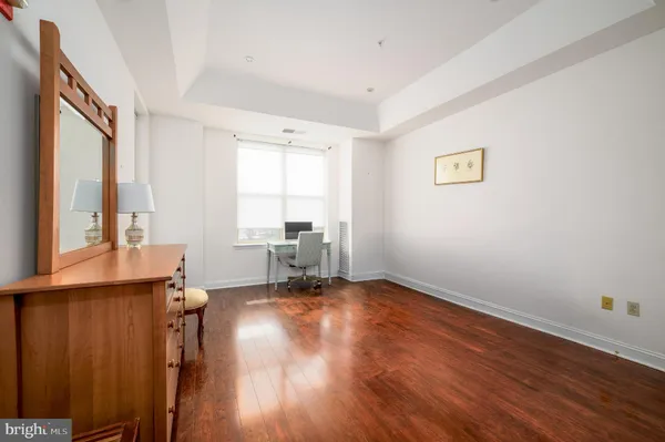 a view of a room with wooden floor and a window