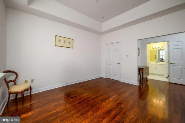a view of a livingroom with wooden floor and a sink