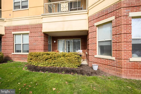 front view of a brick house with a yard