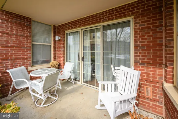 a view of a patio with a table and chairs
