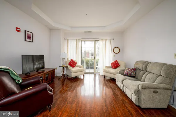 a living room with furniture window and a flat screen tv