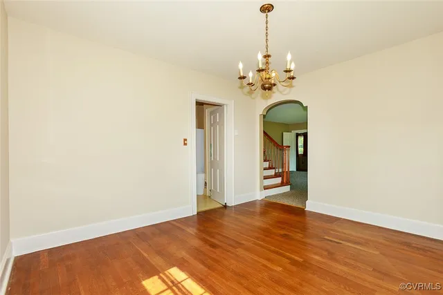 a view of a room with wooden floor and chandelier